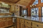 Spacious kitchen with stainless appliances and granite